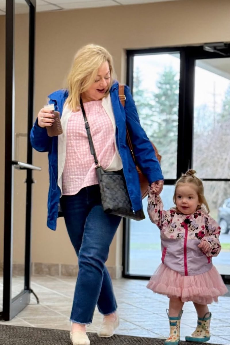 A mom and her young daughter walking in the front doors on a Sunday